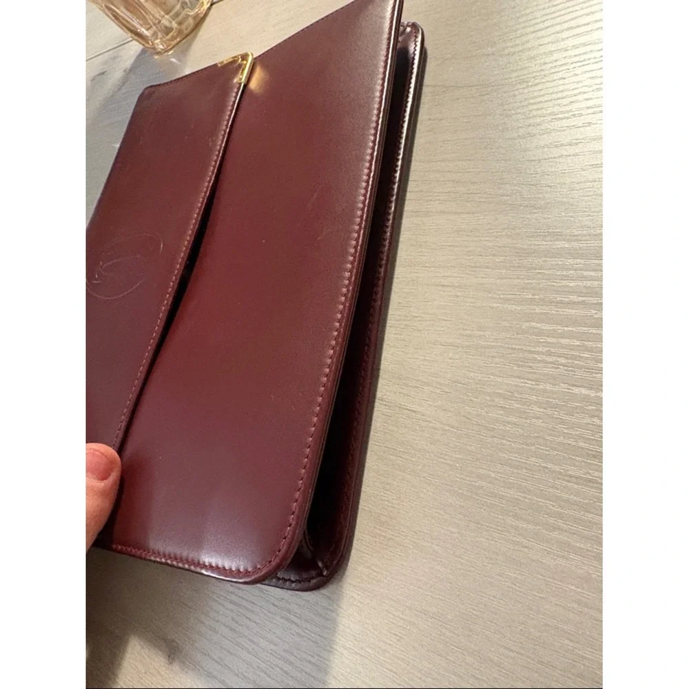 Cartier Burgundy Leather wristlet with Gold Corners‎
